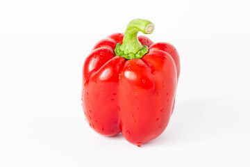 Pepper. Ripe red bell pepper on a white table. Isolated background.