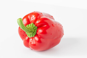 Pepper. Ripe red bell pepper on a white table. Isolated background.