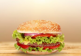 double meet Burger with melting cheddar cheese on background.