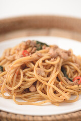 Spicy stir fried Spaghetti with chicken and basil leaf