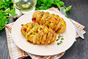Potatoes with smoked bacon in plate on wooden board