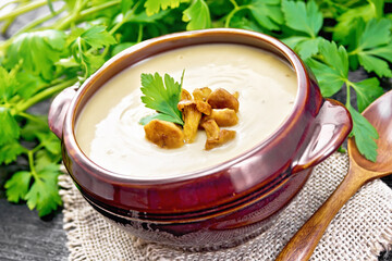 Soup puree of chanterelle in bowl on wooden board