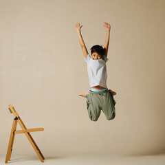 Unsure indian boy jumping up, bending knees and throwing hands up in the air