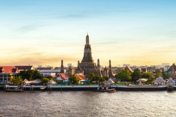 Wat Arun and Chao Phraya River with beautiful sunset sky background, Bangkok, Thailand