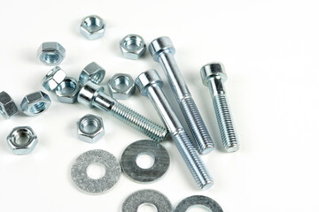 several metal bolts of silvery color on a white background. close-up and copy space