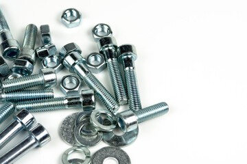 several metal bolts of silvery color on a white background. close-up and copy space