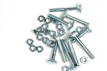 several silver metal bolts with nuts on a white background. close-up and copy space