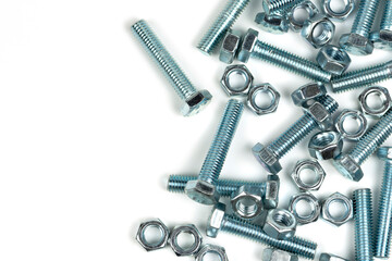 several silver metal bolts with nuts on a white background. close-up and copy space