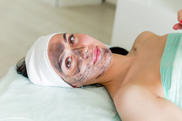 carbon nanogel on woman face. Preparation for procedure carbon peeling with laser rejuvenation in...