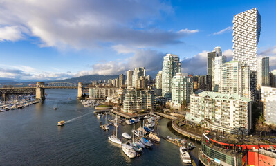 Downtown Vancouver, British Columbia, Canada. False Creek, Burrard Bridge and cityscape skyline in a modern city during sunny winter day.