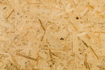 Obraz premium Texture of OSB board. Oriented Strand Boards. Panel of pressed sawdust. Recyclable material. Background