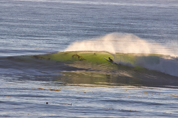 Surfing winter waves along the Old Coast Highway in Ventura