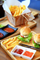 Burgers with tomato, lettuce, cucumber, French fries,onion and cheese