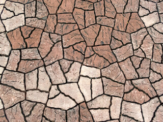 brick pattern texture on the floor in the park It looks like cracked soil gives a feeling of drought. The background gives a feeling of drought.