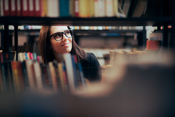 Smart Woman Looking at Bookshelves in a Library