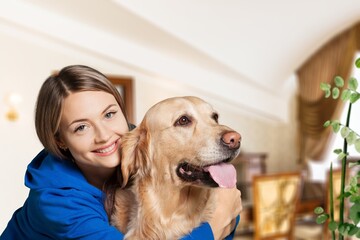 Happy young woman in casual outfit with playful dog, pet and owner
