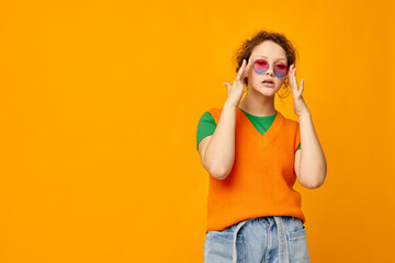 pretty woman sunglasses fashion fun earrings yellow background unaltered