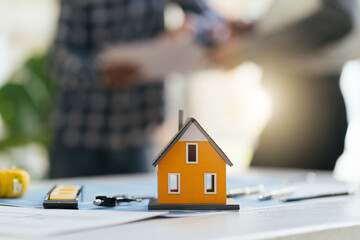 House model on table,Architect or engineer working in office with blueprints,engineer inspection in workplace for architectural plan,sketching a construction project ,Business construction concept.