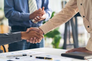 Real estate broker agent and customer shaking hands after signing contract documents for realty purchase, Bank employees congratulate, Concept mortgage loan approval. - obrazy, fototapety, plakaty