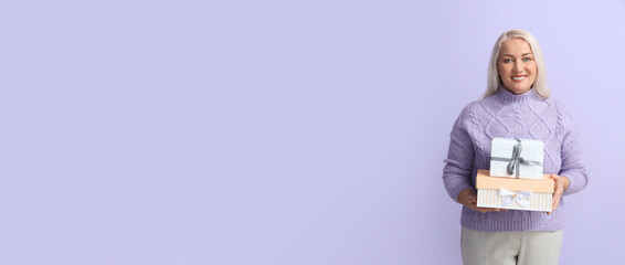 Happy mature woman with gifts on color background with space for text. International Women's Day...