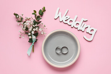 Beautiful composition with wedding rings on color background