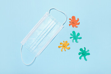 Surgical mask on color background. Virus protection concept