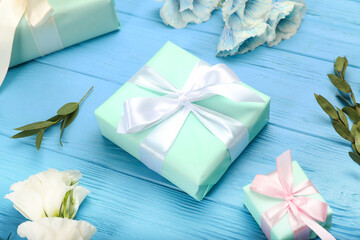 Obraz na płótnie Canvas Beautiful gift boxes on blue wooden background, closeup
