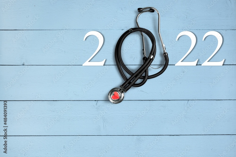 Poster 2022 number with stethoscope. happy new year for heart health and medical concept,