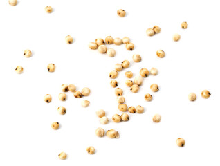 scattered seeds of sorghum groats on a white background
