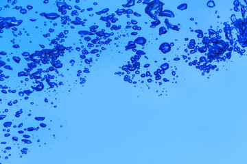 Clear water with air bubbles on blue background