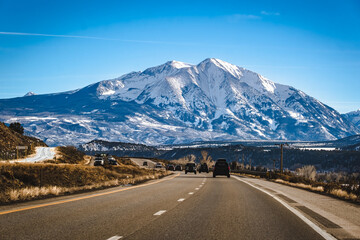 Beautiful view of Colorado mountain peaks with frozen lake in foreground; long shadows on the lake...