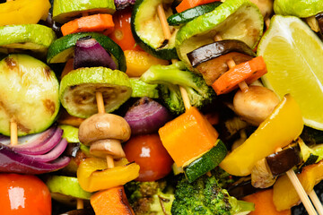 Tasty vegetable skewers on table, closeup