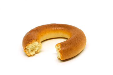 A bitten bagel isolated on a white background