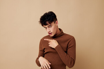 portrait of a young man posing in brown sweater self confidence fashion Lifestyle unaltered