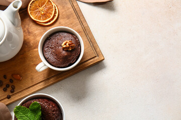 Cups with tasty chocolate brownie on light background