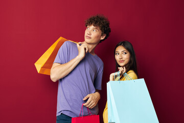 teenagers colorful bags shopping fun red background unaltered