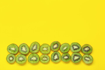 Fresh cut kiwi on yellow background