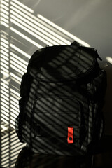 black travel backpack in sunlight