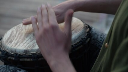 Male hands playing bongo drums, close up. Hand tapping a Bongo drum in close up. Drums hands, movement, rhythm