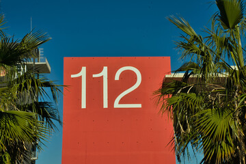 112, emergency number on red background