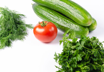 Parsley, dill, with tomato and cucumber on a white background. Food for vegetarians, weight loss
