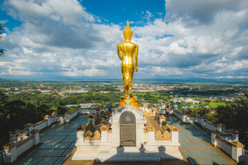 Golden Buddha statue at Wat Phra That Khao Noi, or Phrathat Khao Noi temple, is the top attraction with a fantastic view of Nan province, Thailand