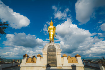 Fototapeta na wymiar Golden Buddha statue at Wat Phra That Khao Noi, or Phrathat Khao Noi temple, is the top attraction with a fantastic view of Nan province, Thailand