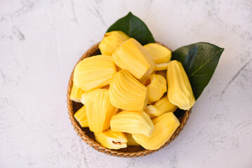 jackfruit on wooden basket with leaf, ripe jackfruit peeled tropical fruit fresh from jackfruit tree