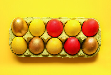 Holder with multicolored Easter eggs on color background