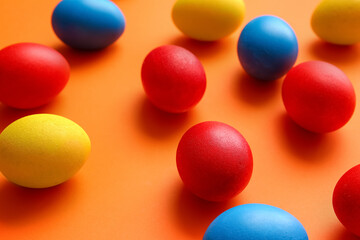 Multicolored Easter eggs on color background