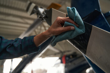 Unrecognized woman using special equipments while working in aviation garage