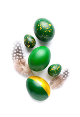Stylish Easter eggs and feathers on white background