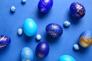 Stylish Easter eggs on blue background