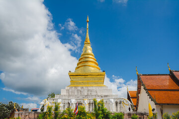 Naklejka premium The golden stupa at Wat Phra That Chang Kham Worawihan or Phrathat Chang Kham Worawihan temple is the one attraction and has famous of Nan province, Thailand